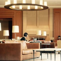woman signing a document at the reception desk